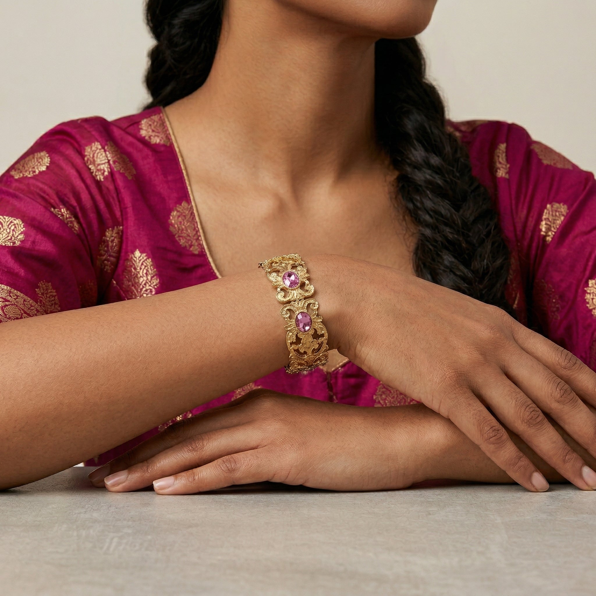 Woman wearing a gold tone Vienna Rose Pink European Crystal Hinge Cuff Bracelet, dressed in a magenta saree.