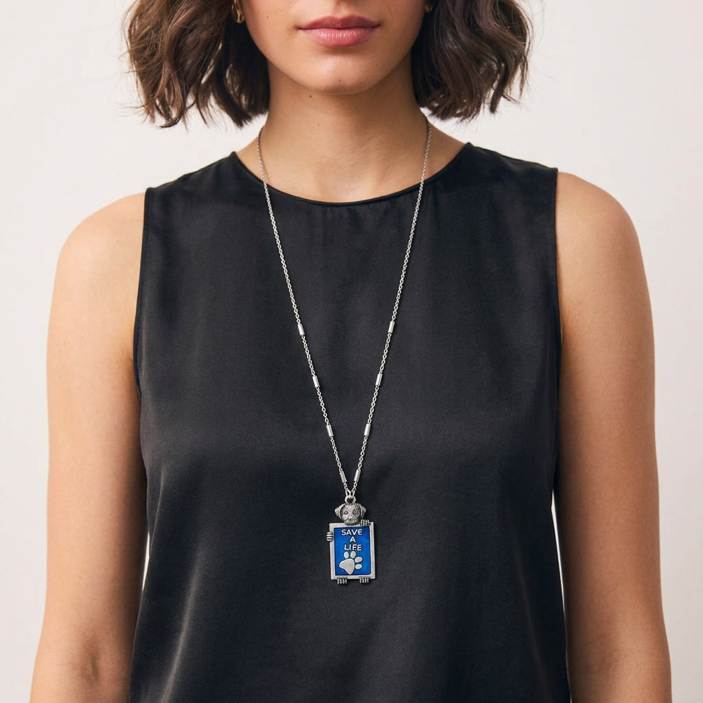 Woman in a black sleeveless top wearing our Pewter Dog Blue Enamel Save A Life Pendant Necklace