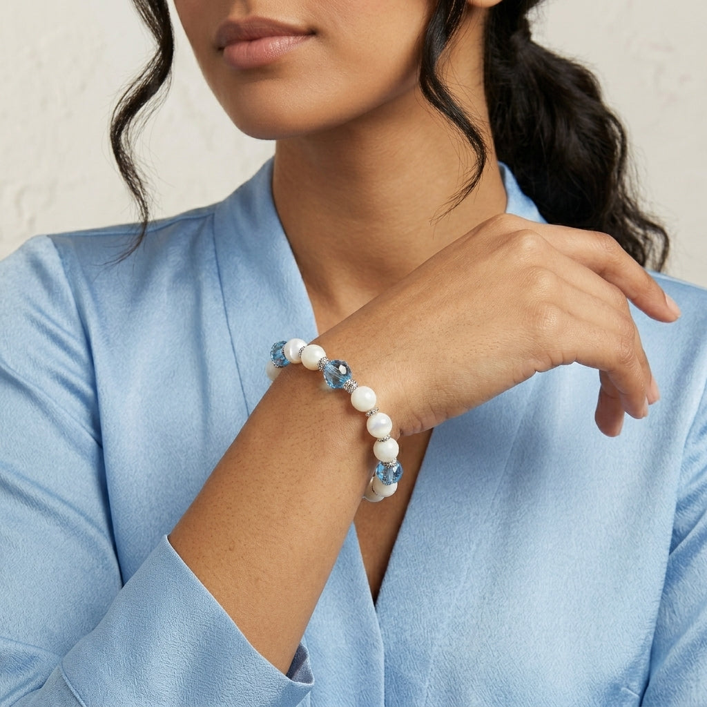 Woman in a blue top wearing our Aquamarine Crystal Mother Of Pearl Stretch Bracelet