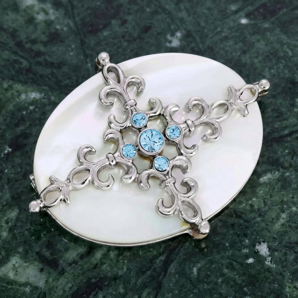 Aquamarine Crystal Mother Of Pearl Filigree Pin on green marble stone surface