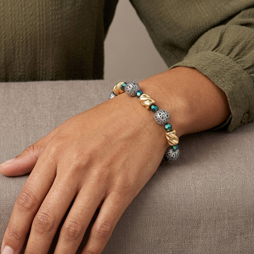 Close up of a woman's wrist wearing our Twisted Bead Filigree Puff Ball Fire Polished Green Bead Link Bracelet