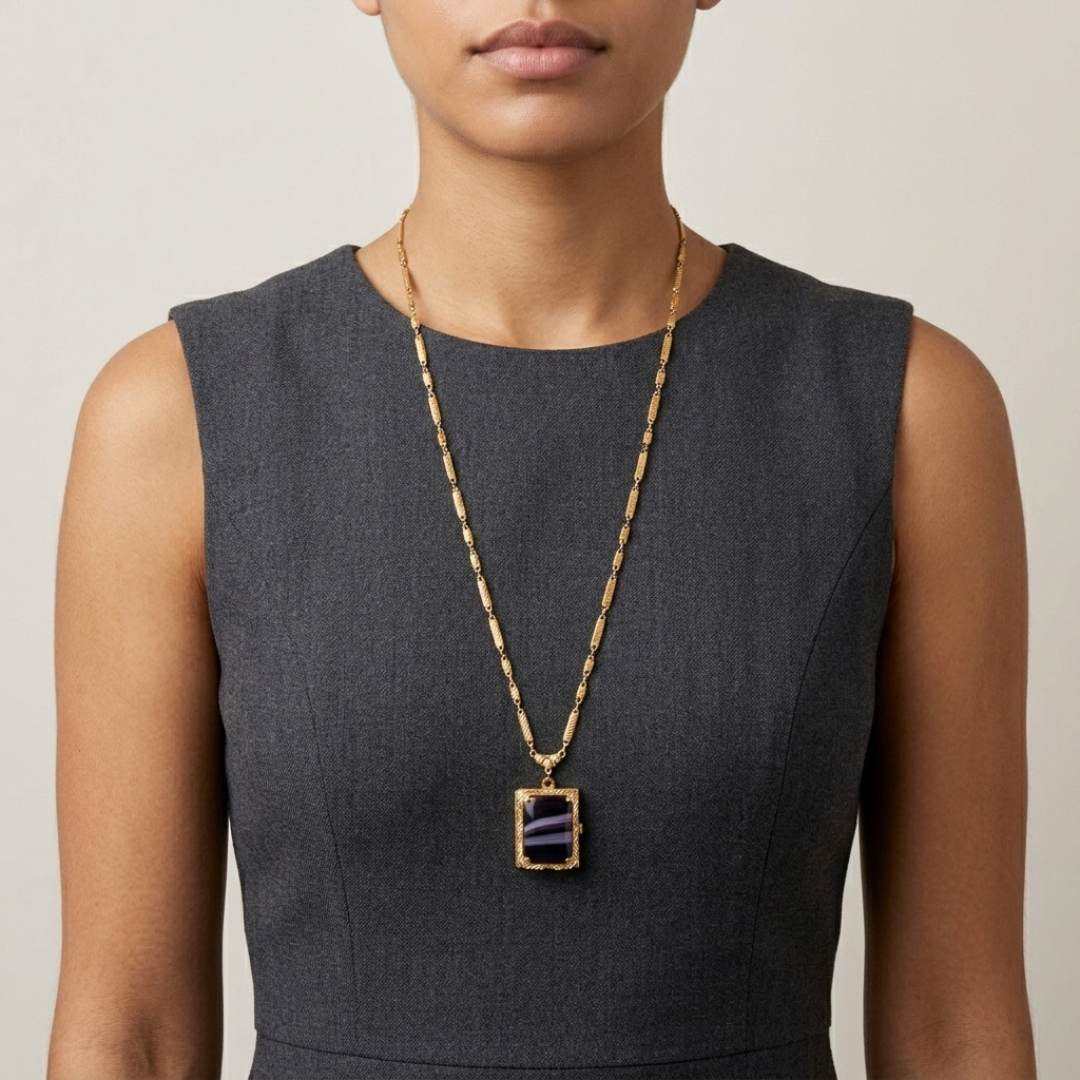 Woman in a dark sleeveless top wearing a purple stone Ol' Family Album Stone Locket Necklace