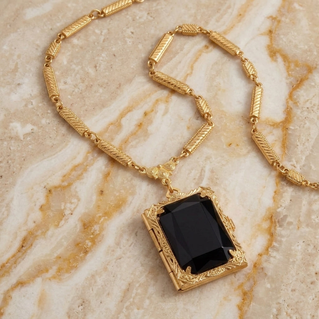 Black Ol' Family Album Stone Locket Necklace resting on beige stone granite surface