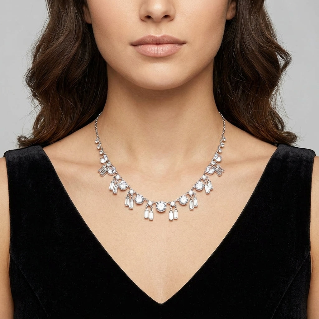 Woman wearing a sparkling vintage Austrian crystal necklace against a neutral background