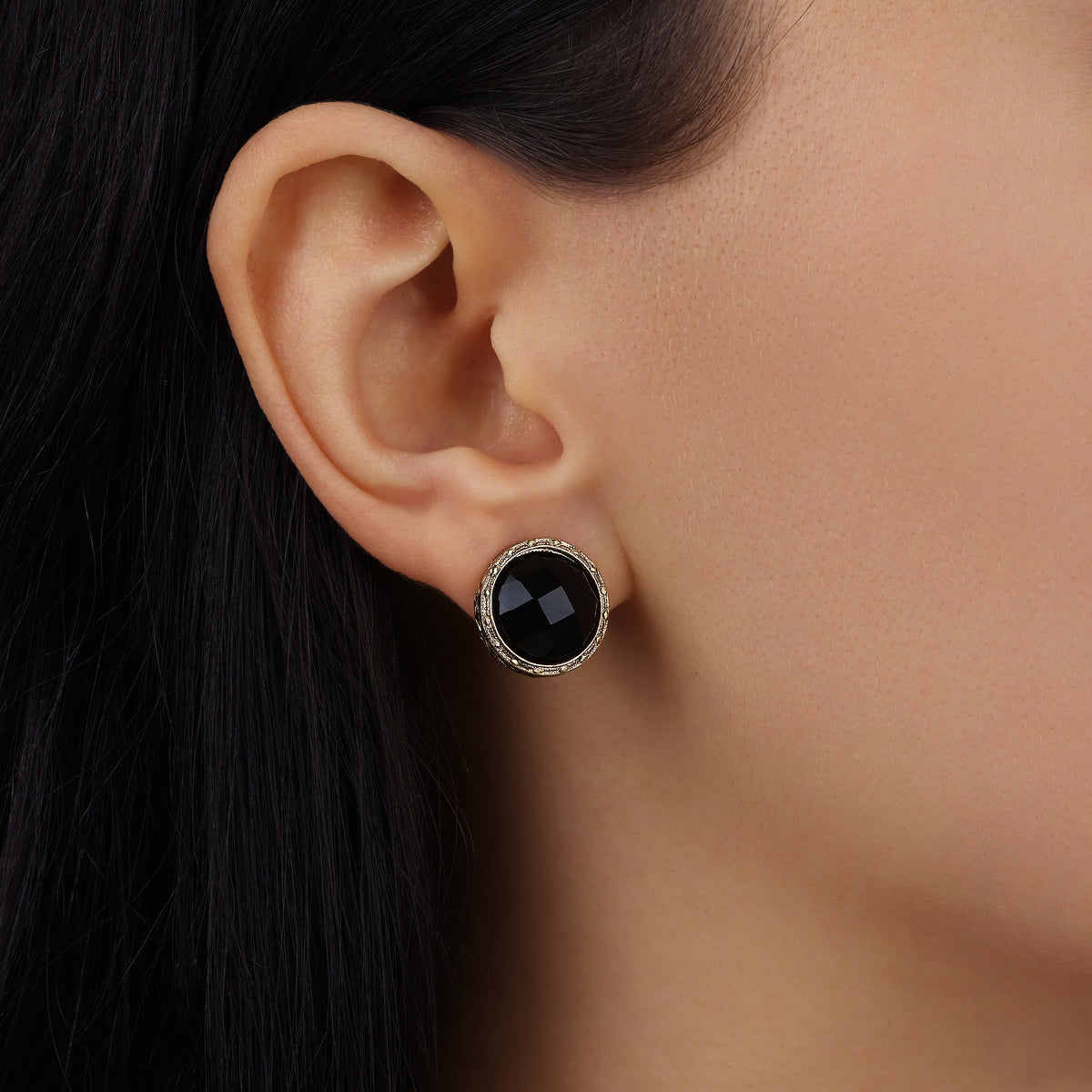 Woman wearing these Black Round Faceted Stone Button Clip On Earrings in a close up model shot