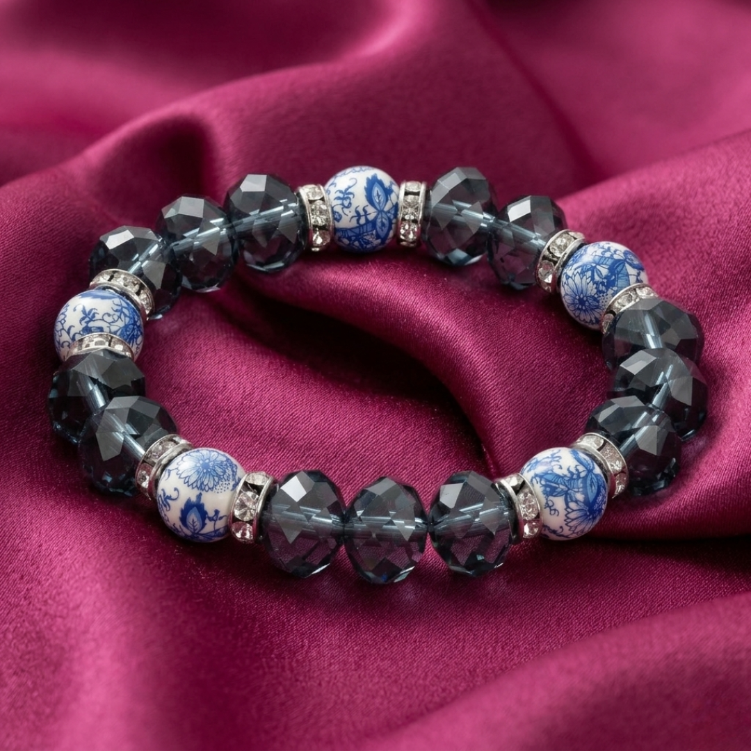 Bracelet with blue and white beads on a pink fabric background