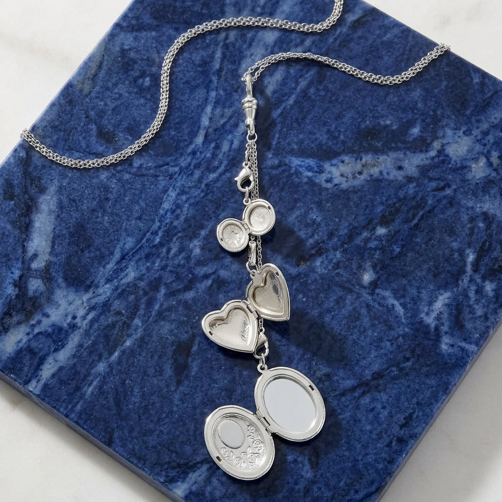 Opened Multi Charm Heart & Oval Black Cameo Locket Necklace resting on blue marble stone surface