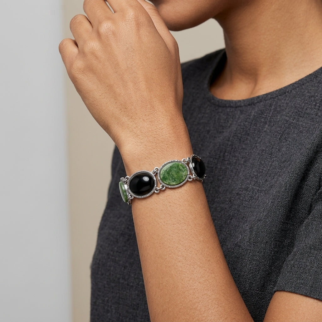 Woman in a gray shirt wearing a Silver tone Onyx & Jade Gemstone Link Bracelet on her wrist