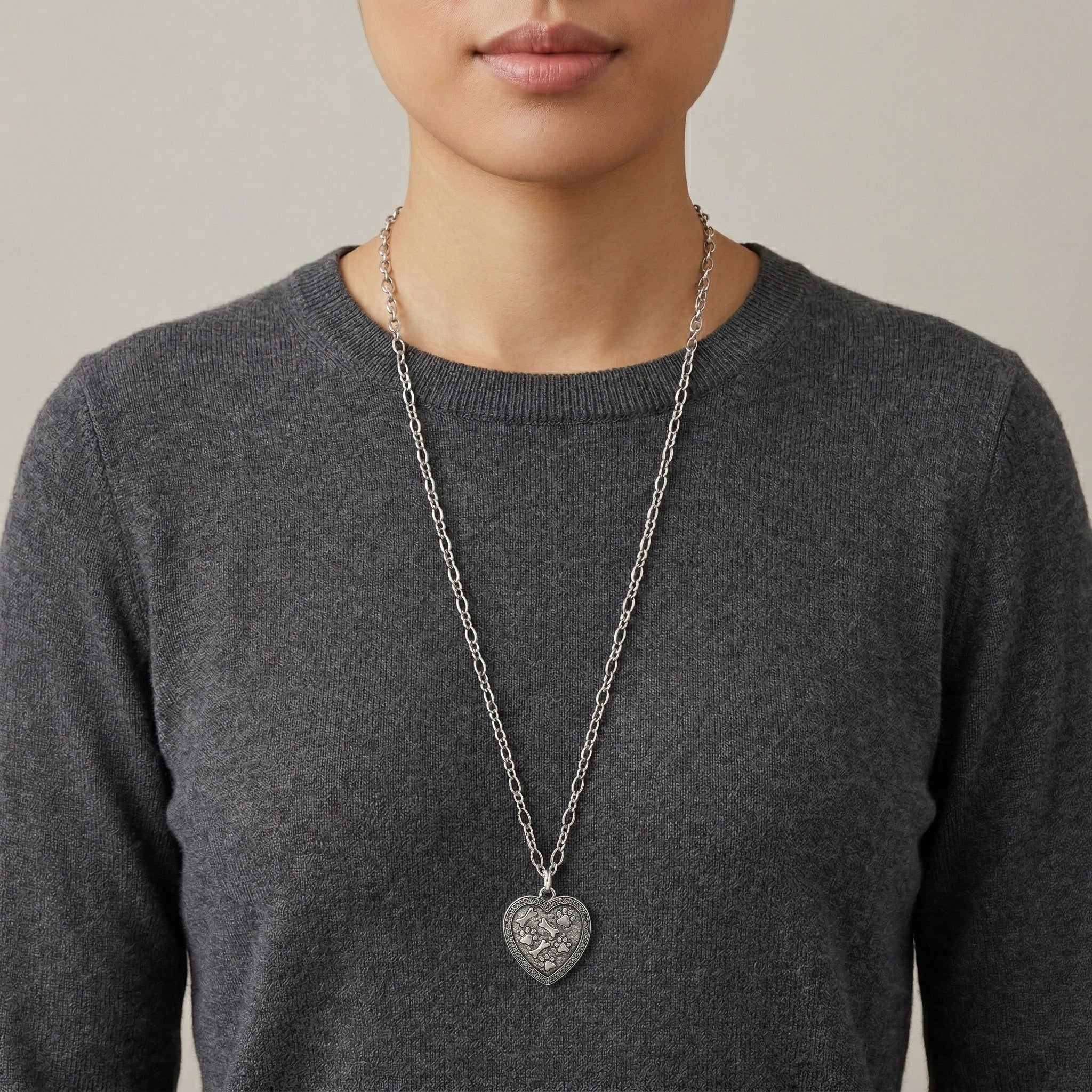 Model wearing a Pewter Heart Paws And Bones Pendant Necklace