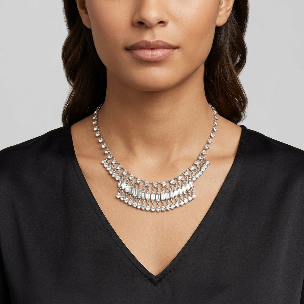 Woman wearing a silver tone vintage Austrian crystal necklace against a gray background