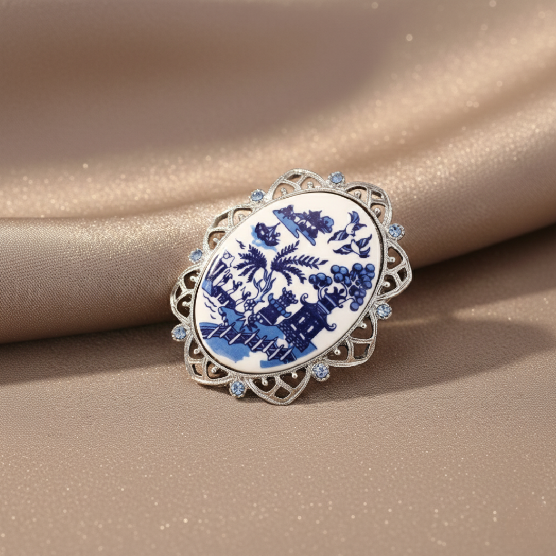 Decorative brooch with blue and white design on a beige fabric background