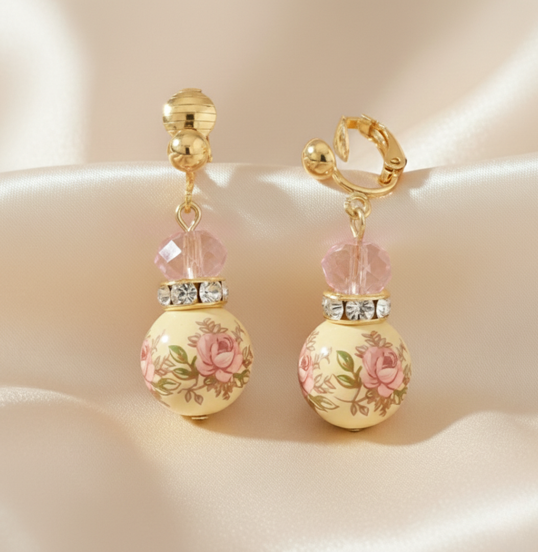 Pair of earrings with floral design on a beige background