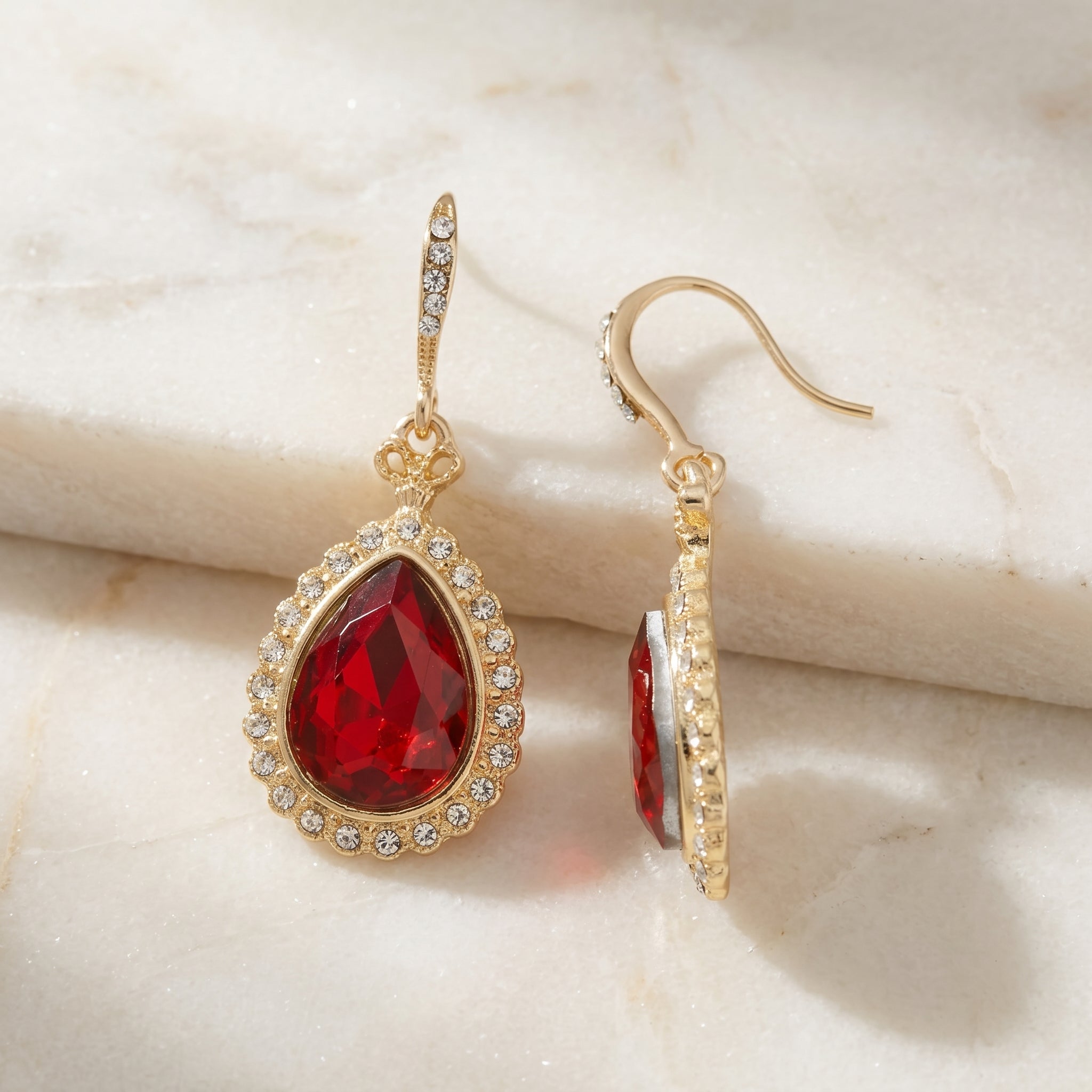 Siam Red Stone Teardrop Crystal Drop Earrings on marble surface