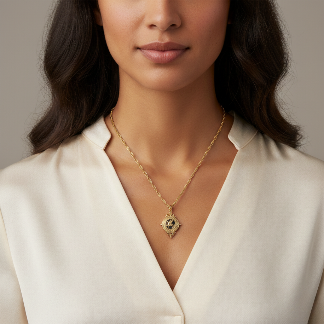 Woman wearing a gold necklace with a pegasus pendant against a neutral background