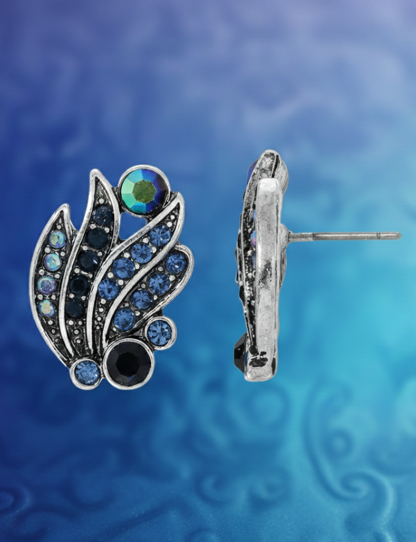 Silver earrings with gemstones on a blue and purple gradient background