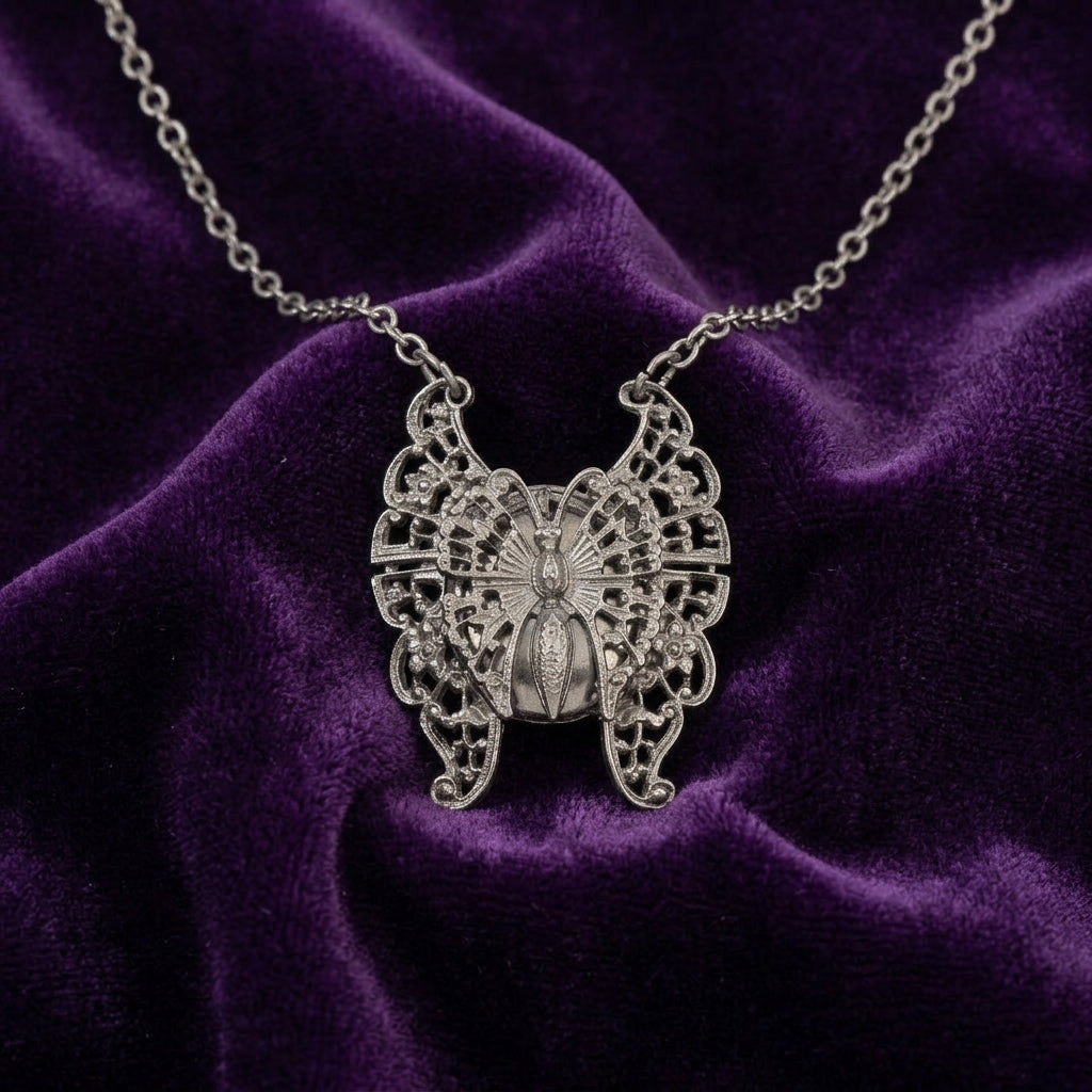 Silver butterfly locket pendant necklace on a purple velvet background