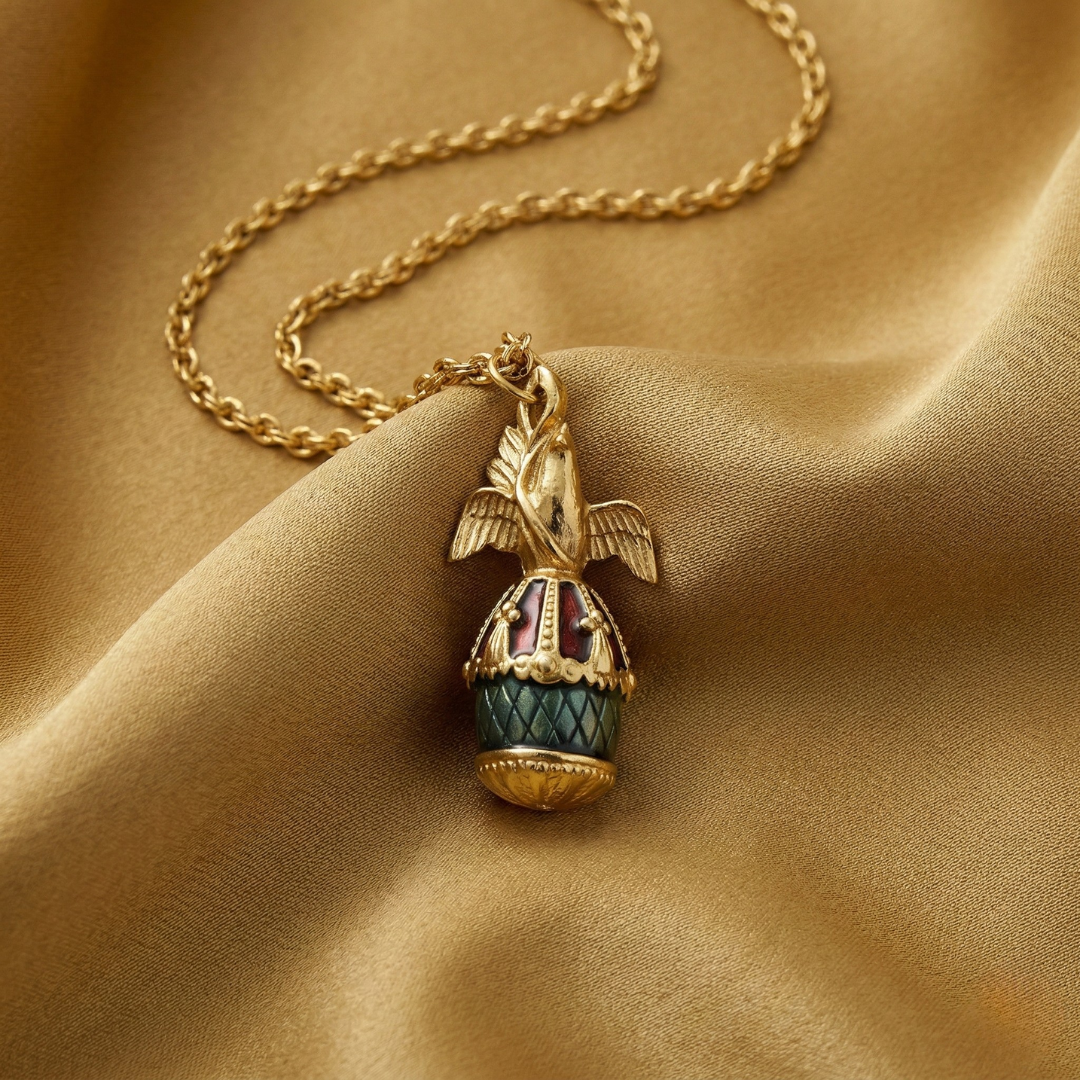 Decorative necklace with a dove bird and egg pendant on a beige fabric background