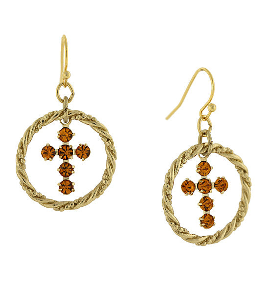 Gold earrings with circular designs and brown gemstones on a white background