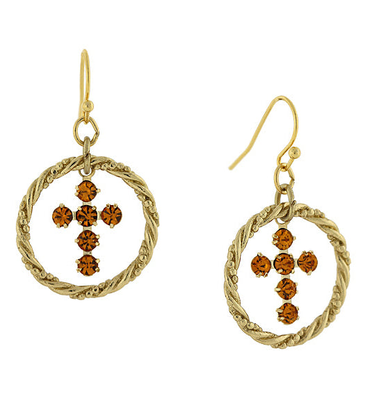 Gold earrings with circular designs and brown gemstones on a white background
