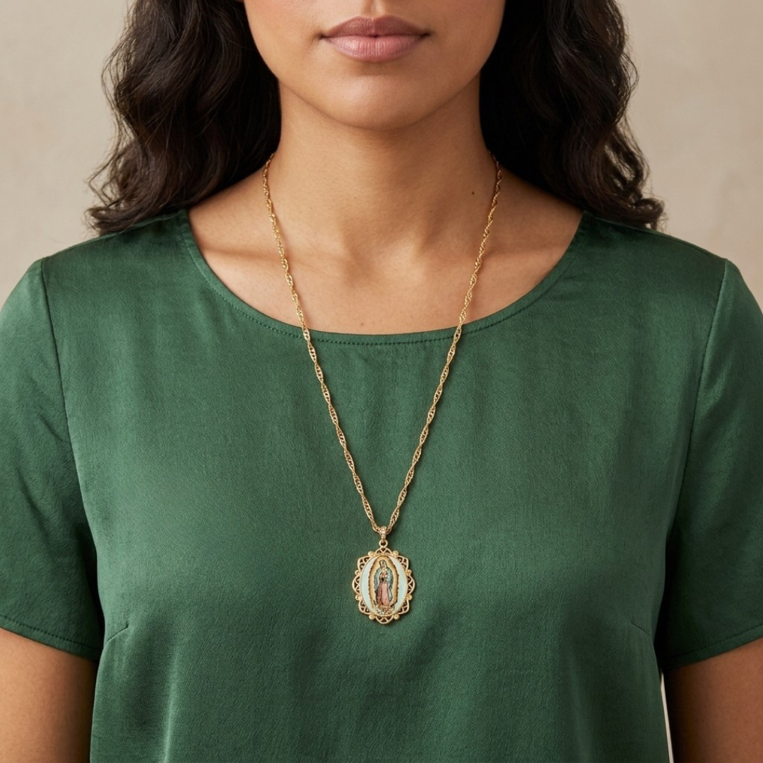 Woman wearing a green shirt and gold necklace with a pendant.
