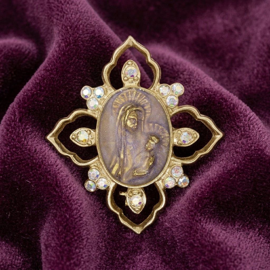 Decorative brooch with religious Mother Mary and Child design on a purple fabric background