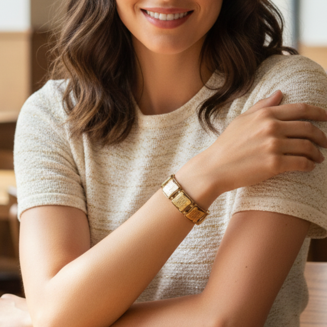 Woman wearing a gold bracelet, smiling with a blurred background