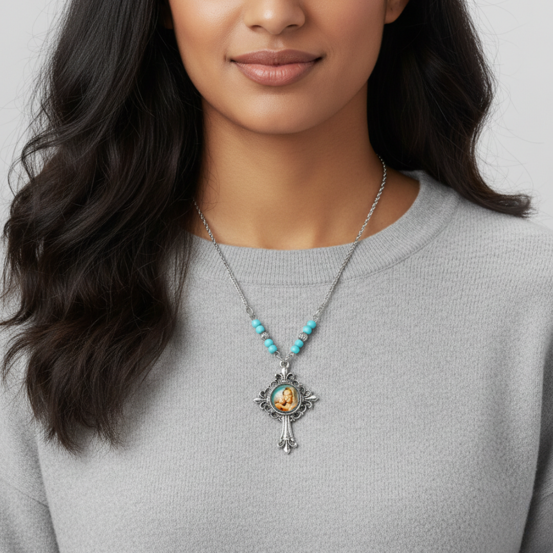 Woman wearing a religious necklace with a pendant on a plain background