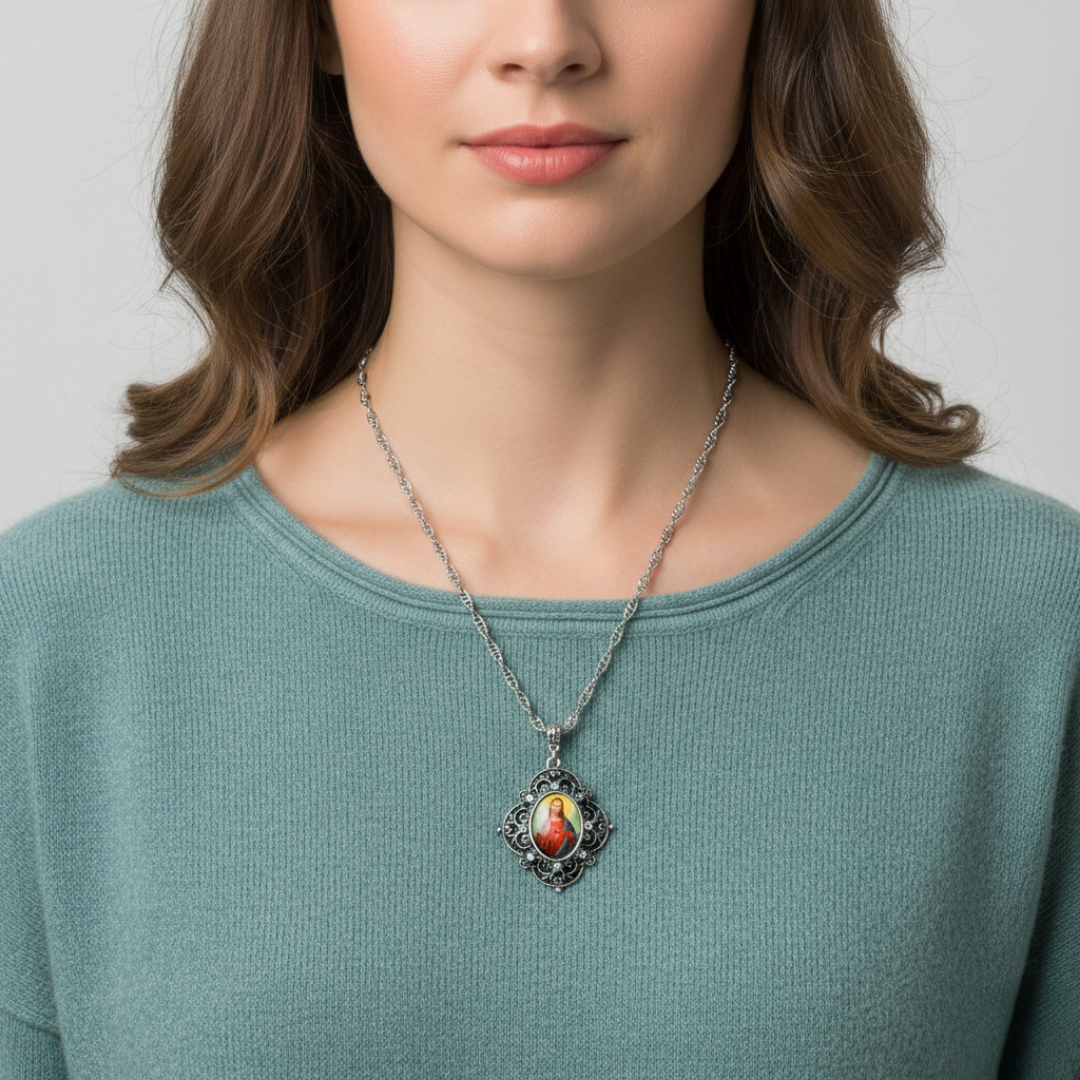 Woman wearing a necklace with a Jesus pendant against a neutral background