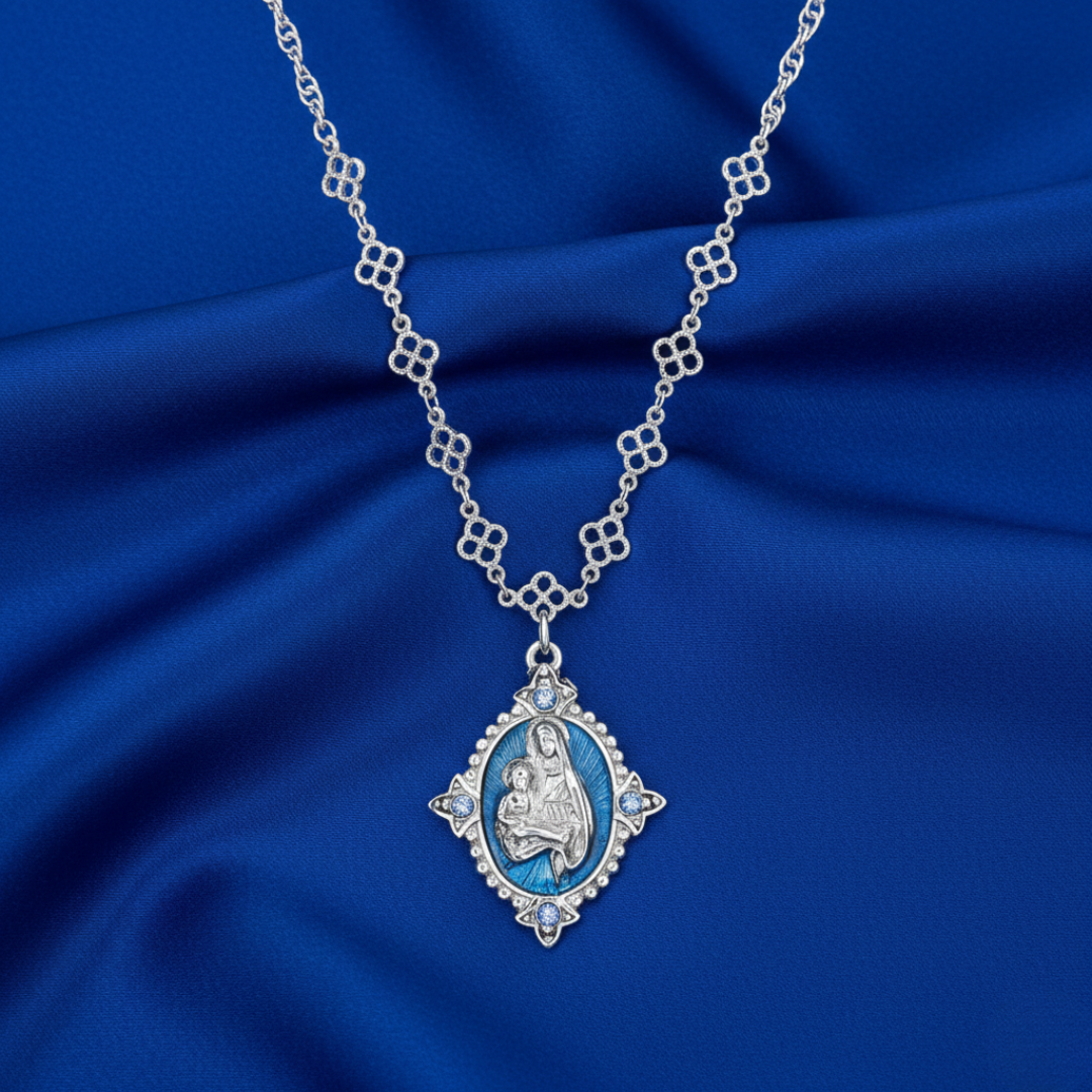 Silver necklace with a pendant on a blue fabric background