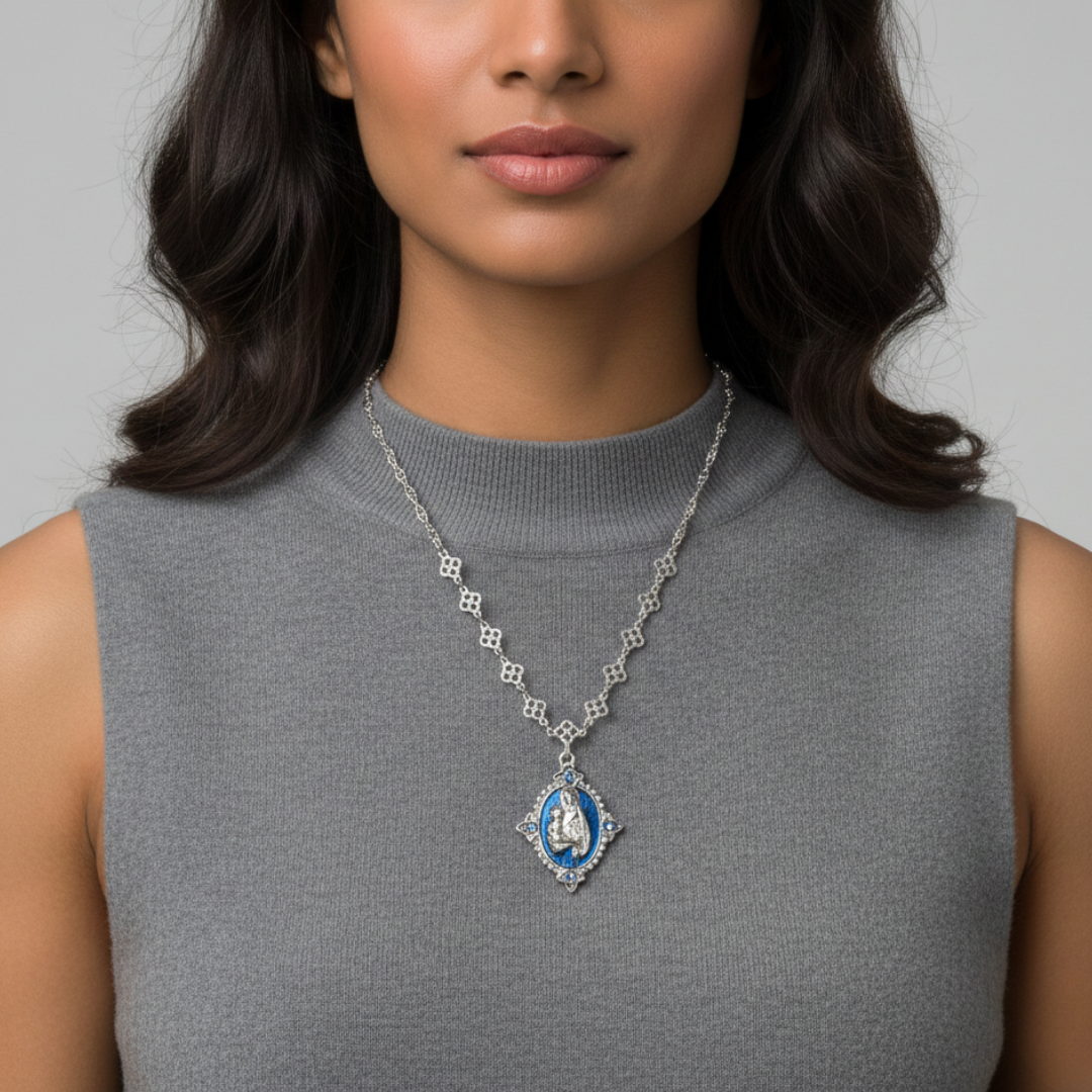 Woman wearing a necklace with a blue pendant against a neutral background
