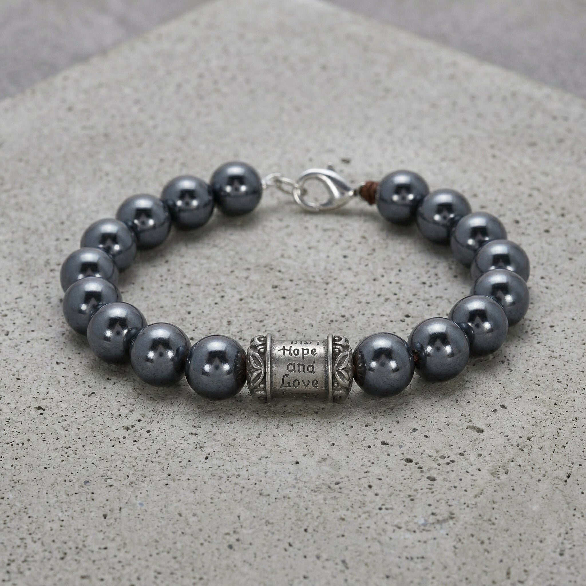 Black Faux Pearl & Prayer Bead Bracelet on cement