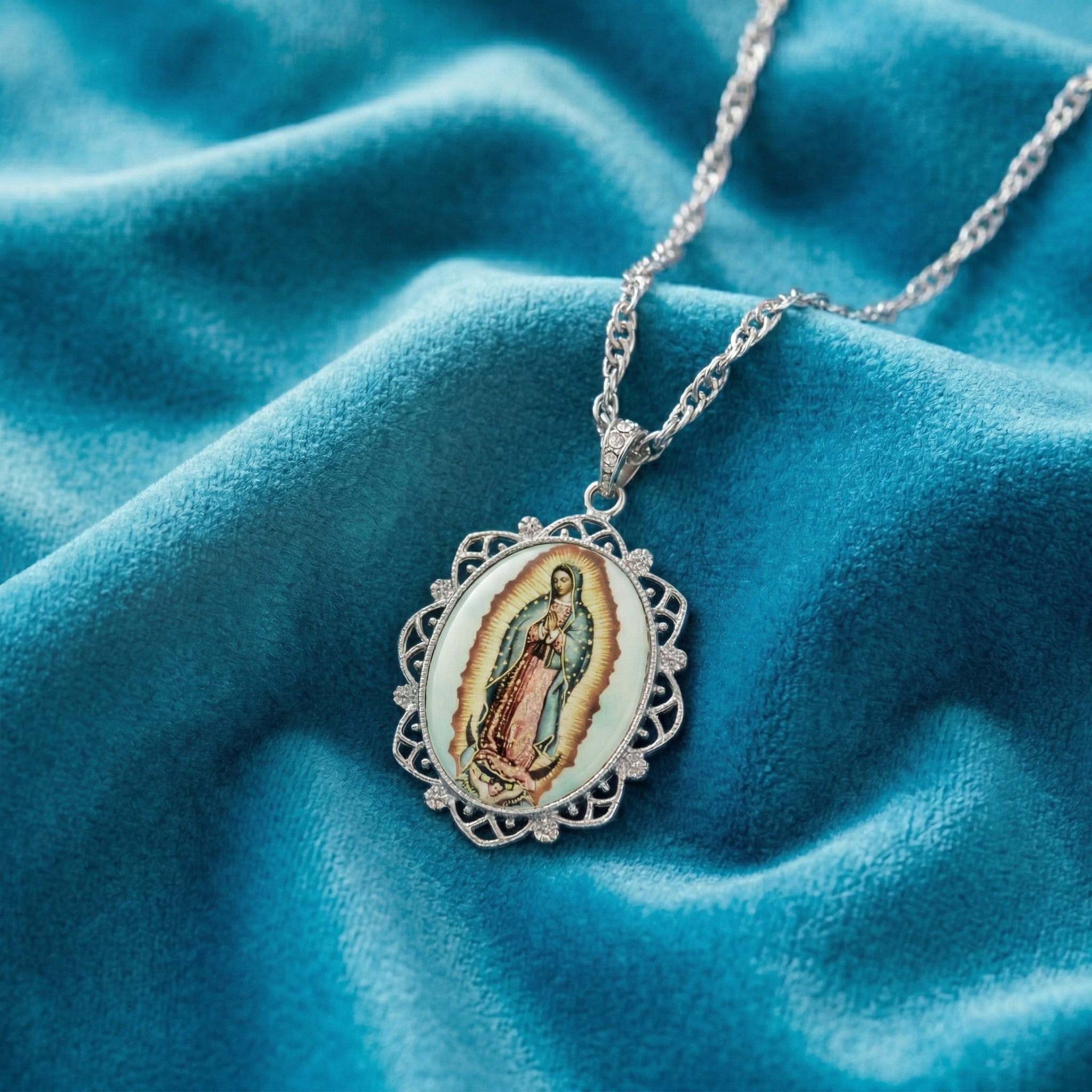 Necklace with a pendant featuring a religious icon on a blue fabric background