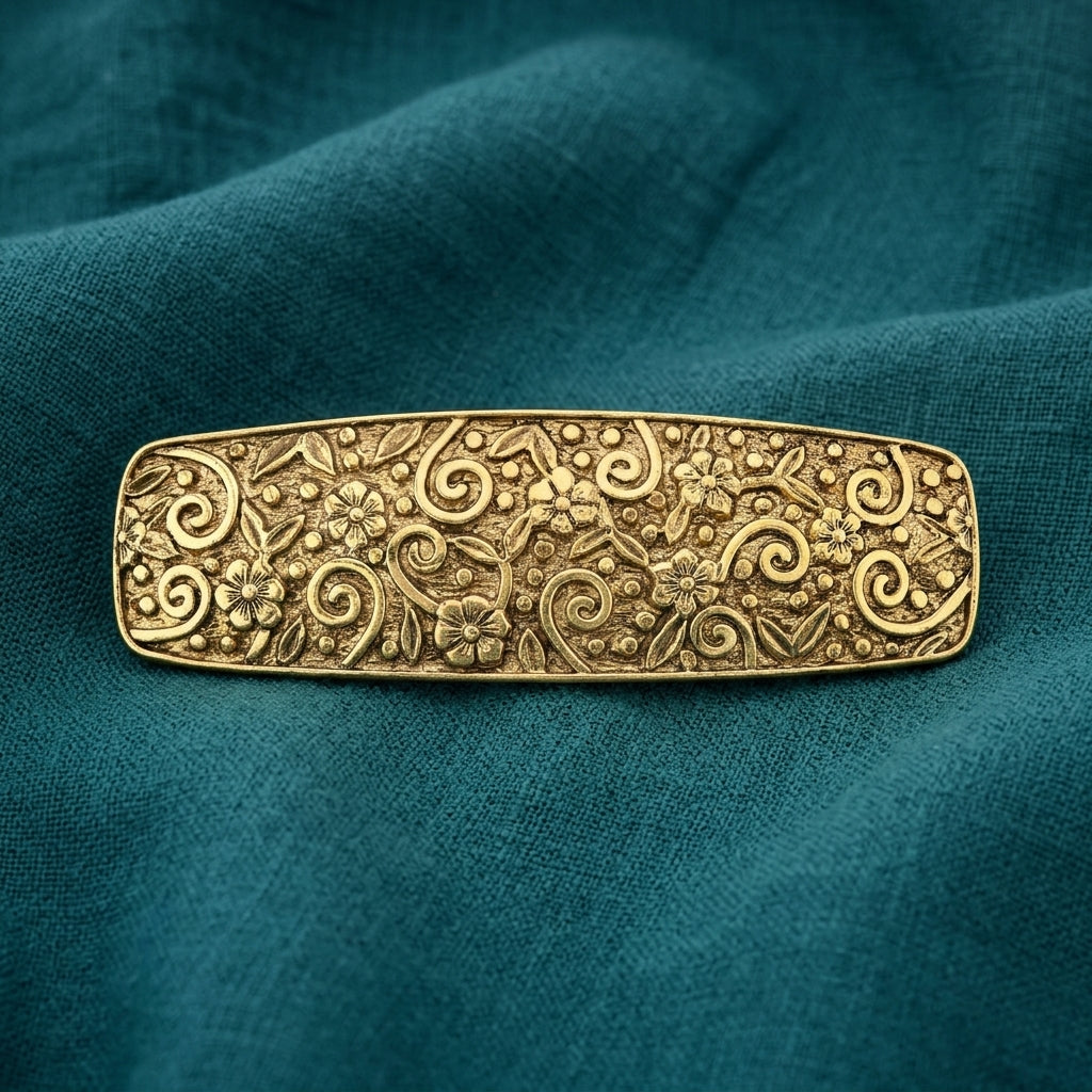 Gold Floral Hair Barrette on a teal fabric background