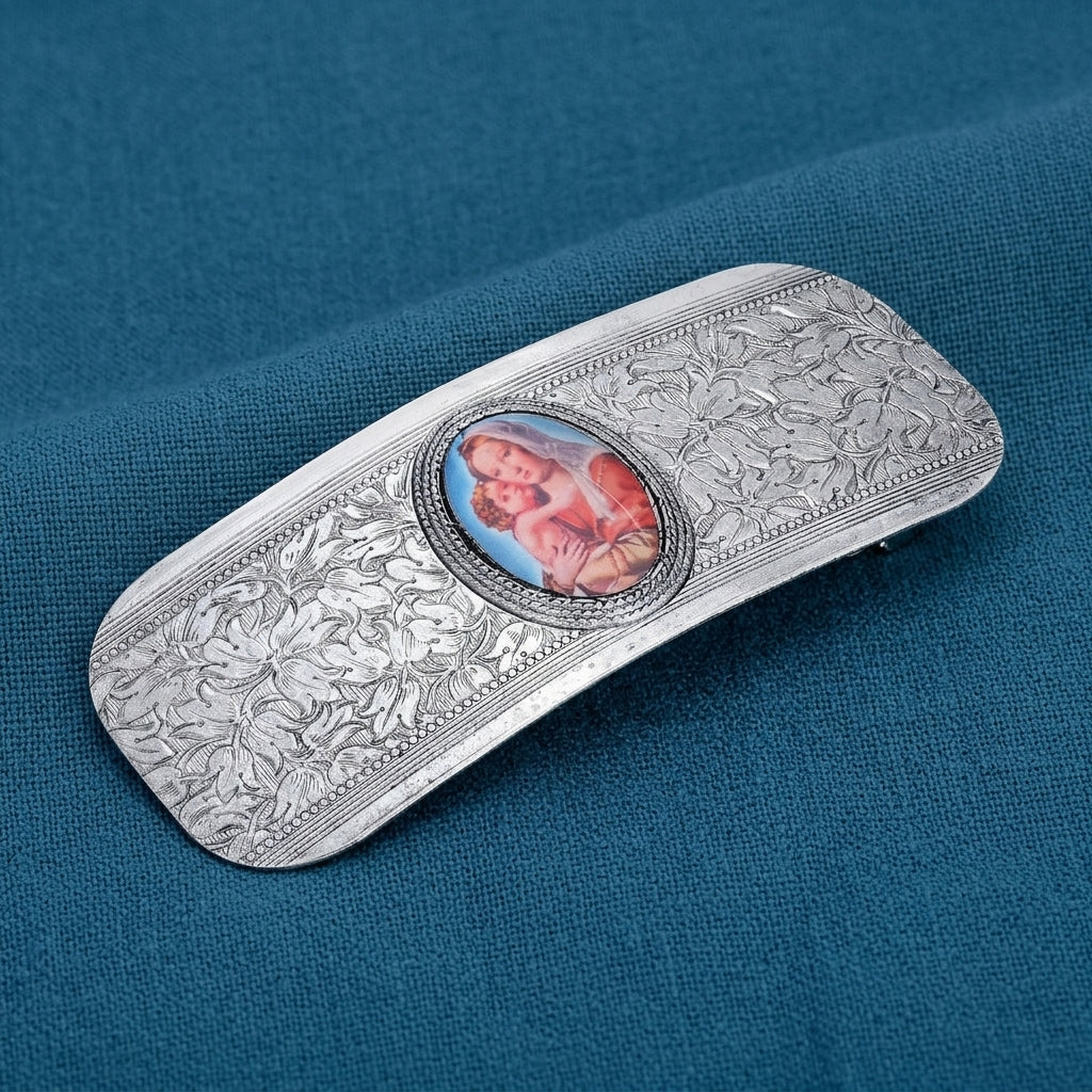 Madonna and Child Floral Hair Barrette on a blue fabric background
