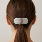 Silver Madonna and Child Floral Hair Barrette in a person's hair against a neutral background