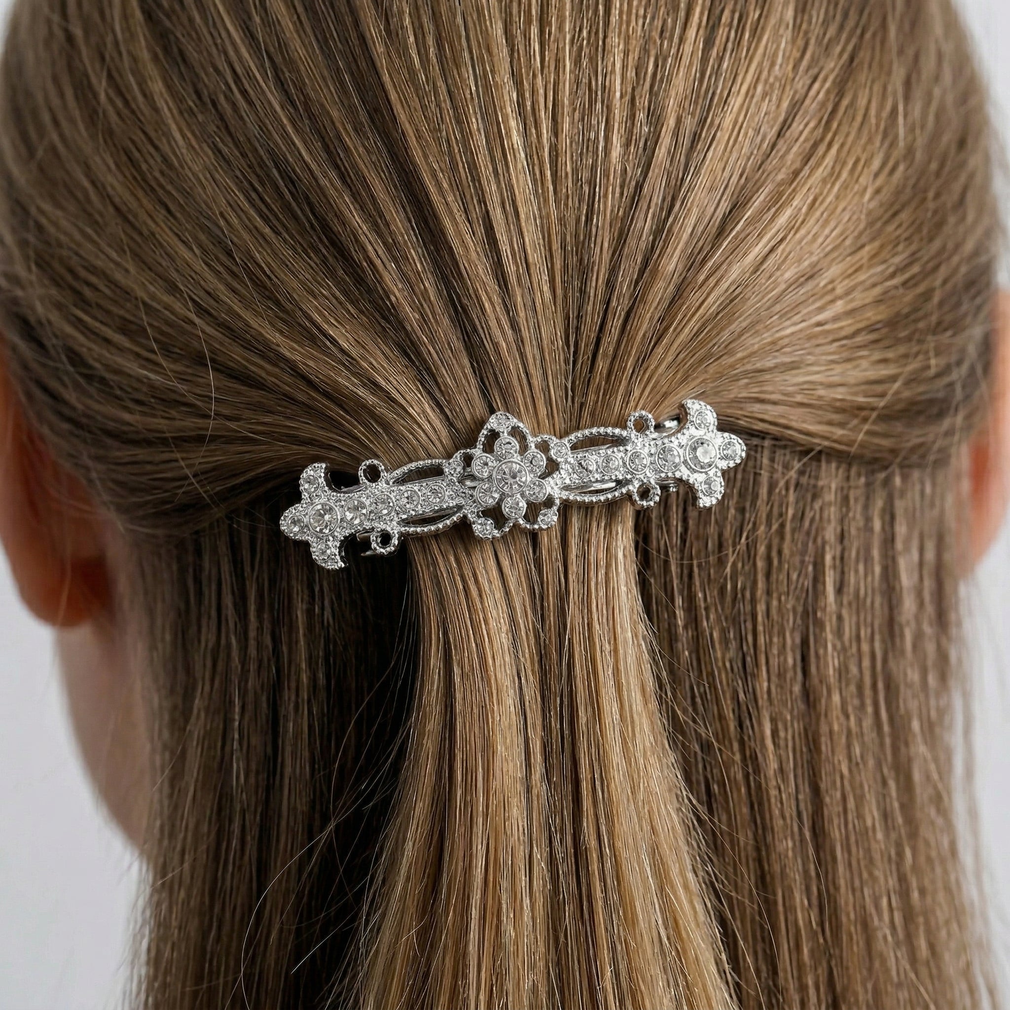 Woman wearing a Fleur De Cristal Bridal Bar Barrette in her hair