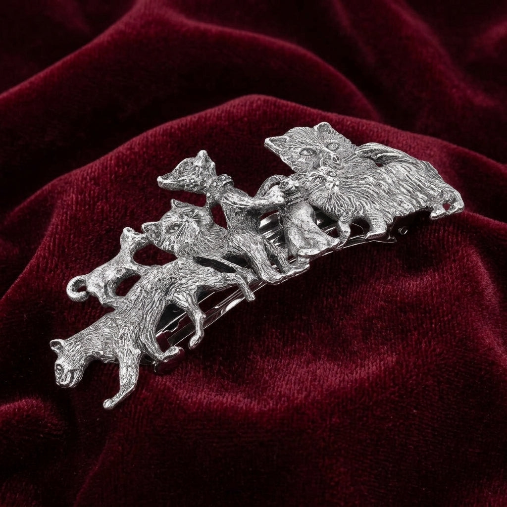 Silver tone Cat Clique Hair Barrette on a red velvet background