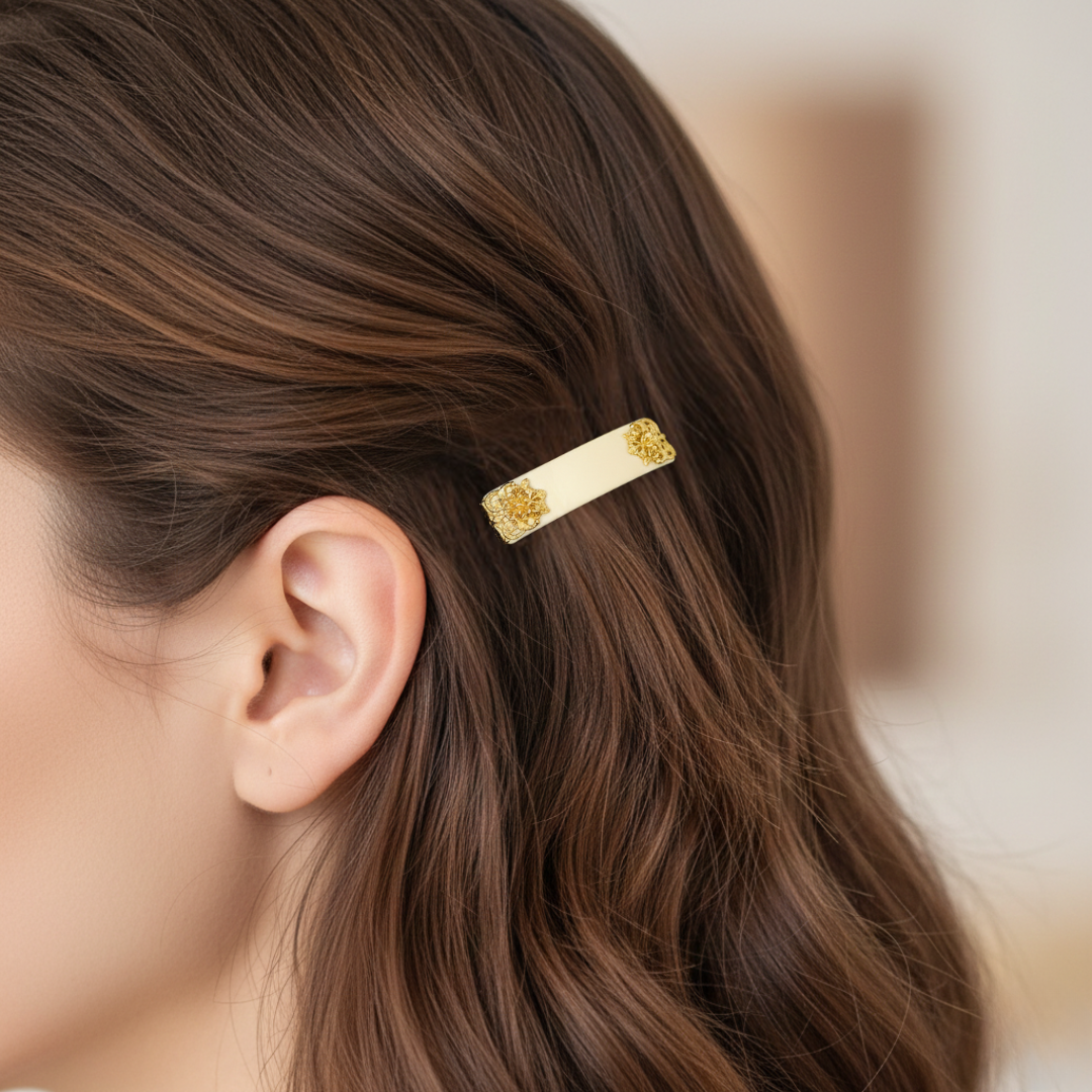 Gold hair clip in a person's hair with a blurred background.