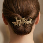 Hair bun with decorative hair barrette featuring multiple dog breeds on a neutral background