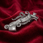Silver tone Seamstress Essentials Hair Barrette on a red fabric background