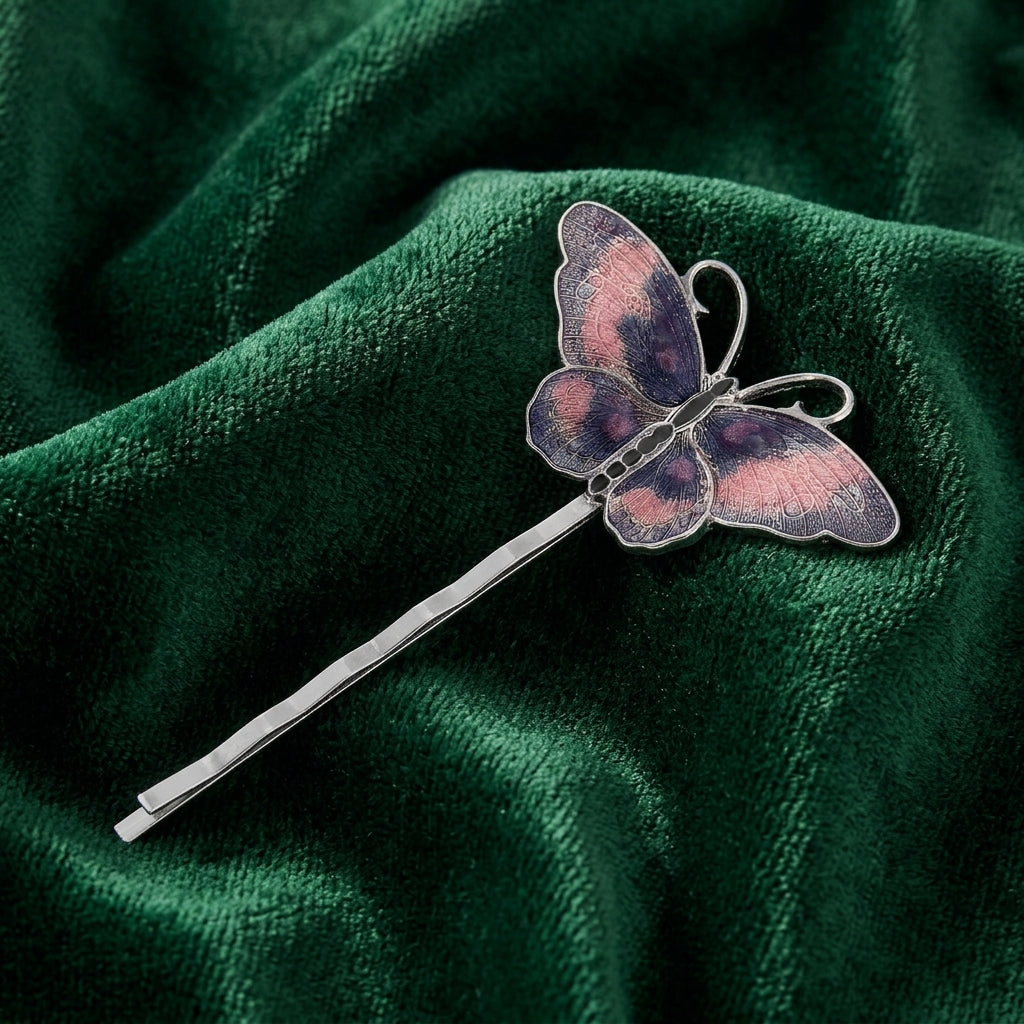 Dark Navy Blue & Pink Butterfly Bobby Pin on a green fabric background