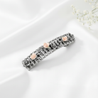 Decorative hair barrette with floral elements on a white surface.