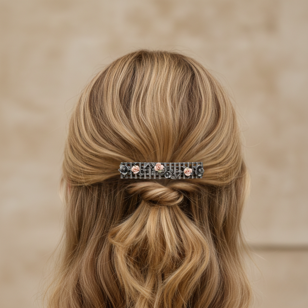 Barrette with floral design in a styled hair on a beige background.