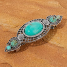 Turquoise Stone Floral Hair Barrette on a brown stone background