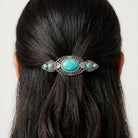 Woman with dark hair wearing Turquoise Stone Floral Hair Barrette
