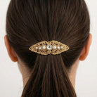 Gold tone Splendor Filigree & Stones Hair Barrette in a woman's bun with dark hair