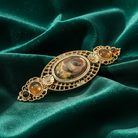 Decorative hair clip on a green fabric background