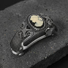 Decorative barrette with a cameo design on a dark stone surface