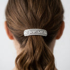 Woman wearing a silver floral design barrette