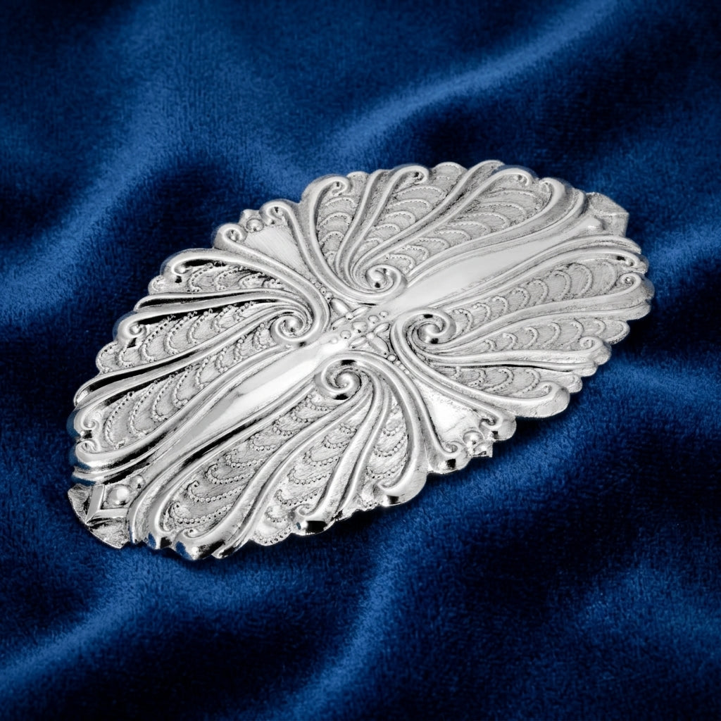 Silver hair barrette on blue satin fabric